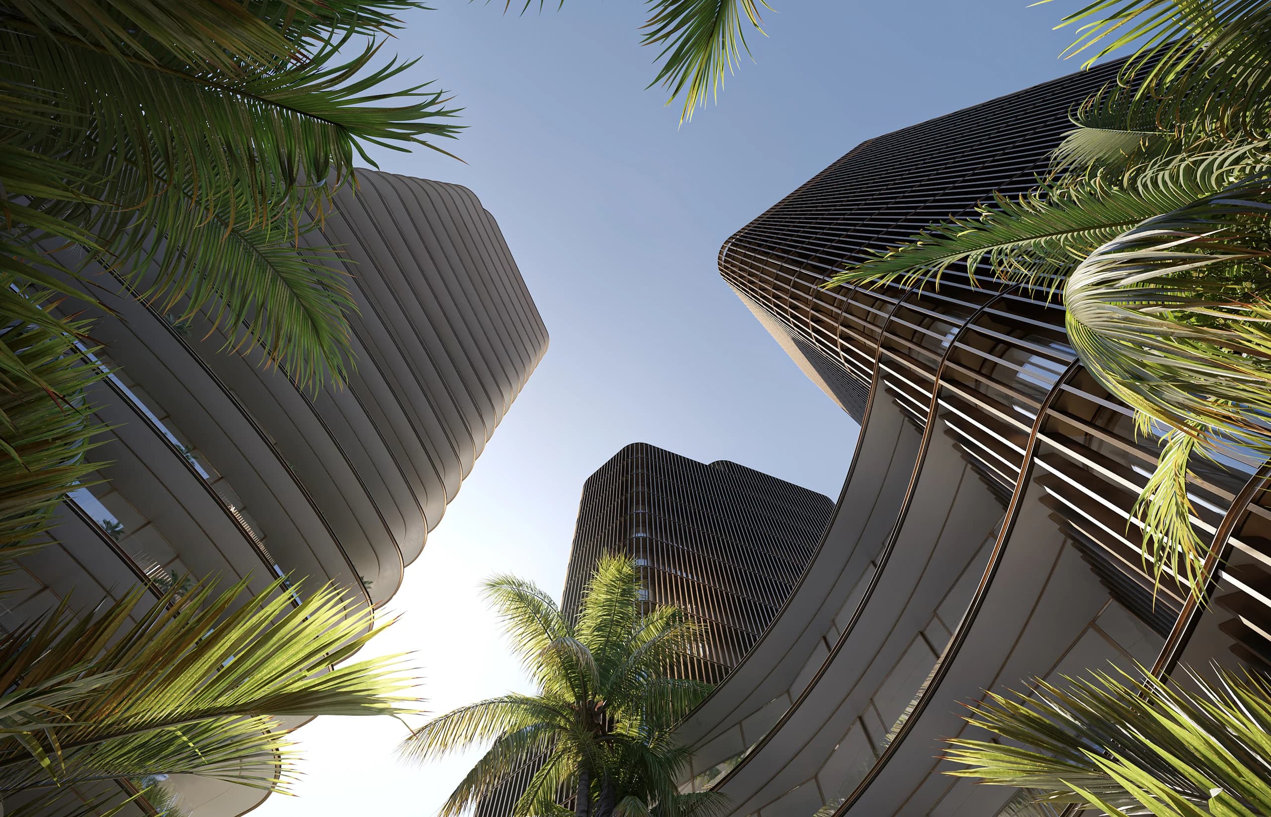 Curved residential towers framed by palms